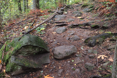 Mather Road natural surface trail with large rocks scattered across width
